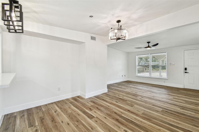 10011 N Annette Ave, Tampa, FL 33612 - unfurnished dining area with a chandelier, wood finished floors, and a ceiling fan