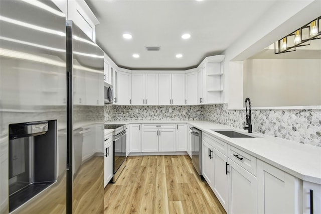 10011 N Annette Ave, Tampa, FL 33612 - kitchen with appliances with stainless steel finishes, open shelves, white cabinetry, light countertops, and recessed lighting