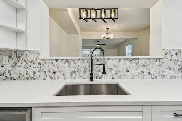 10011 N Annette Ave, Tampa, FL 33612 - kitchen featuring a chandelier, white cabinets, and backsplash