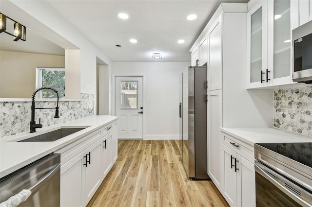 10011 N Annette Ave, Tampa, FL 33612 - kitchen with stainless steel appliances, backsplash, recessed lighting, white cabinetry, and light countertops