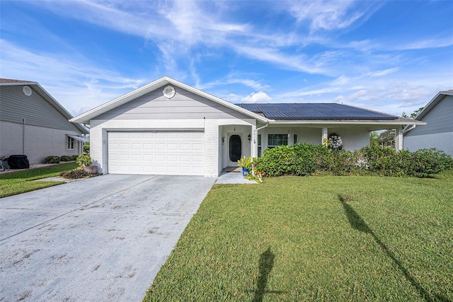 ranch-style house with an attached garage, a front lawn, roof mounted solar panels, and brick siding