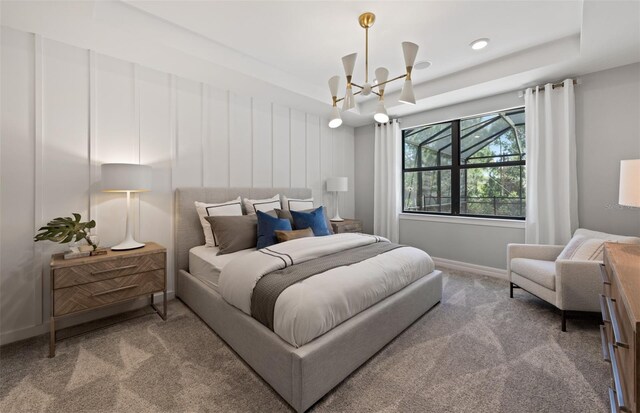 5953 Bluestar Ct, Lakewood Ranch, FL 34211 - bedroom featuring carpet floors, a raised ceiling, baseboards, and a chandelier