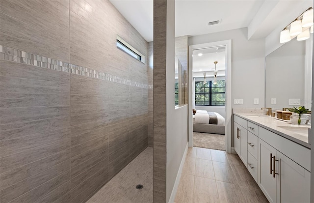 5953 Bluestar Ct, Lakewood Ranch, FL 34211 - full bath featuring visible vents, double vanity, walk in shower, a sink, and ensuite bath