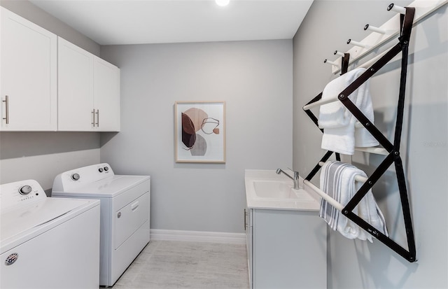 5953 Bluestar Ct, Lakewood Ranch, FL 34211 - clothes washing area with a sink, baseboards, cabinet space, and washer and clothes dryer