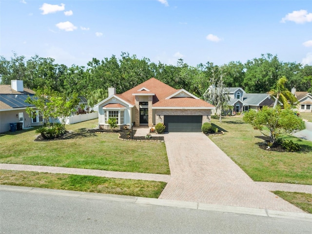 4317 74th Ave E, Sarasota, FL 34243 - single story home featuring a garage, decorative driveway, and a front yard