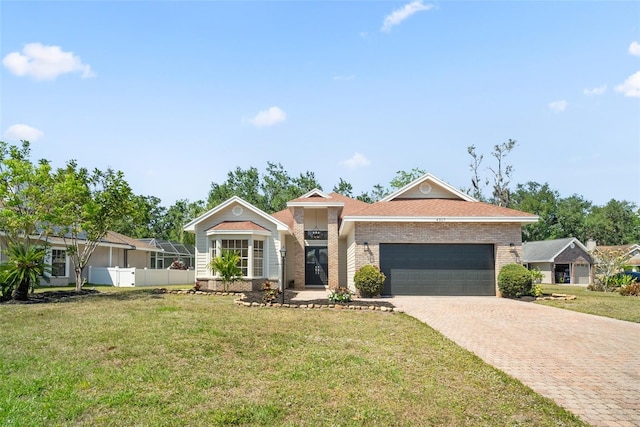 4317 74th Ave E, Sarasota, FL 34243 - ranch-style home featuring an attached garage, decorative driveway, and a front yard
