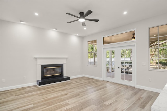 4317 74th Ave E, Sarasota, FL 34243 - unfurnished living room with light wood-type flooring, a ceiling fan, recessed lighting, and french doors