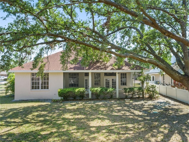 4317 74th Ave E, Sarasota, FL 34243 - view of front of home featuring fence, a front yard, stucco siding, french doors, and a shingled roof