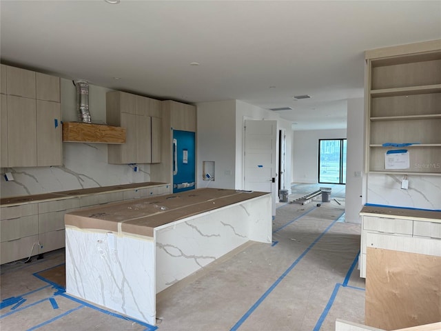 501 W Ross Ave Unit 1, Tampa, FL 33602 - kitchen featuring modern cabinets, a kitchen island, and tasteful backsplash