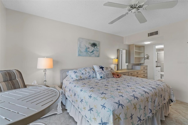bedroom with light tile patterned flooring, ensuite bath, a ceiling fan, and visible vents
