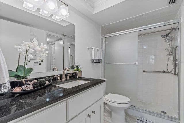 bathroom featuring vanity, toilet, visible vents, and a stall shower