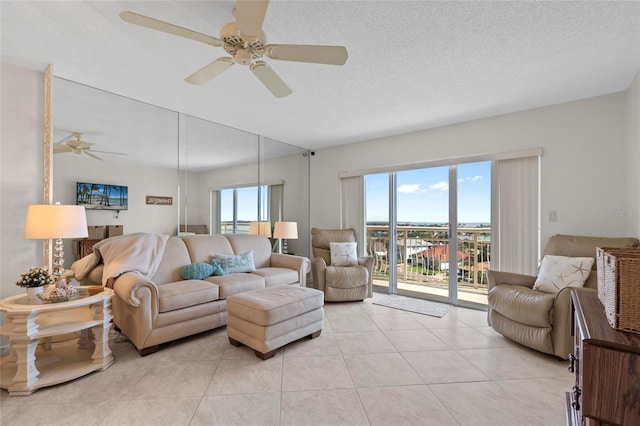 living room with light tile patterned floors and a ceiling fan