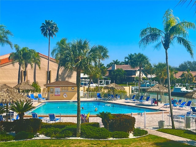 pool with a patio and fence