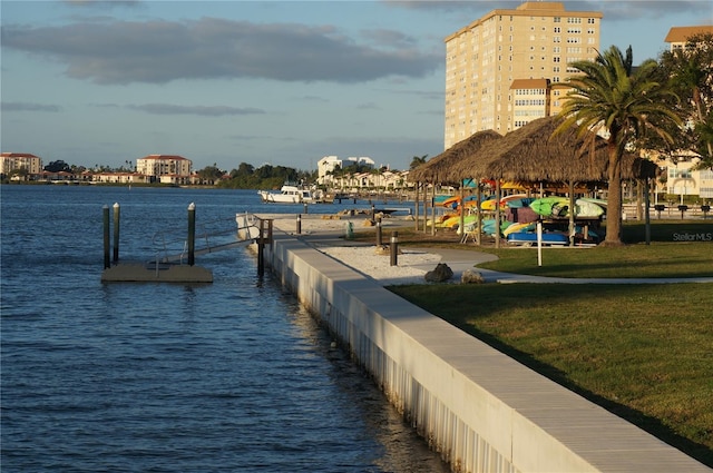 dock area with a yard and a water view