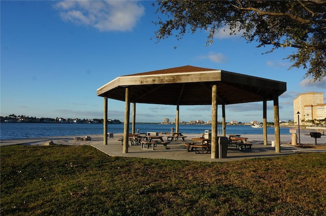 surrounding community with a gazebo, a water view, and a yard