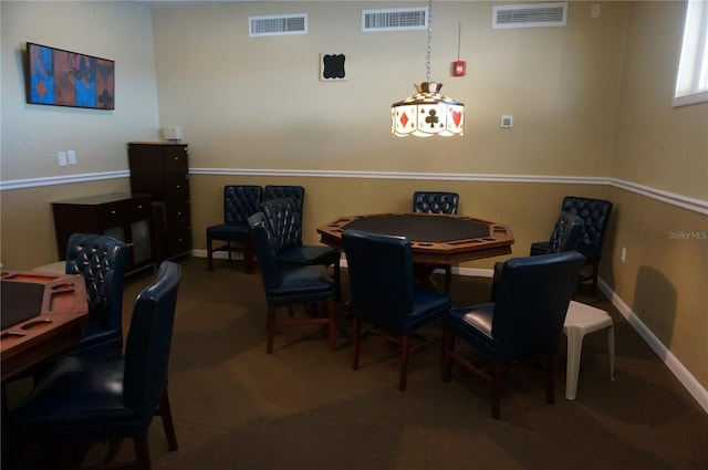 dining space featuring baseboards, visible vents, and carpet
