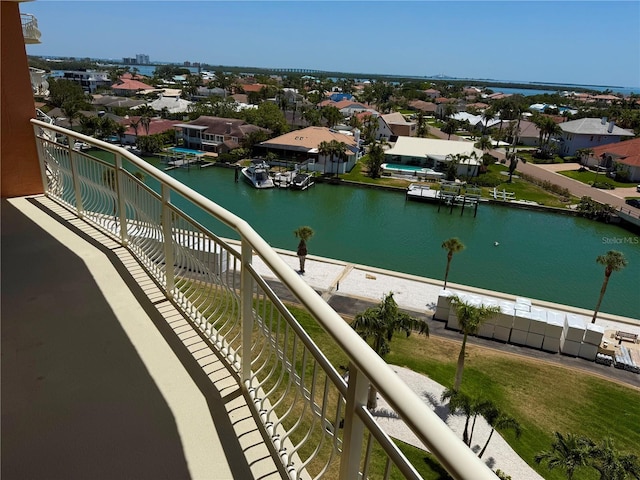 balcony with a residential view and a water view