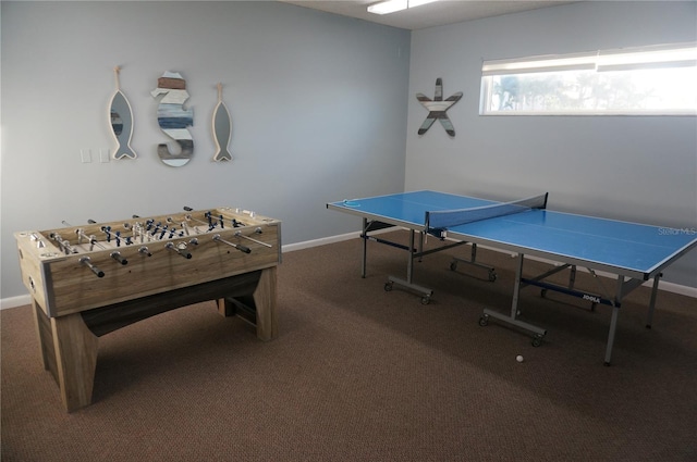 rec room featuring baseboards and carpet flooring