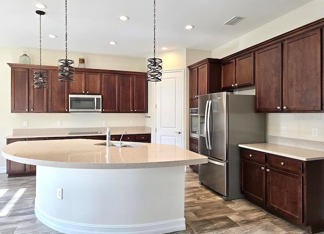kitchen with decorative light fixtures, visible vents, appliances with stainless steel finishes, a sink, and recessed lighting
