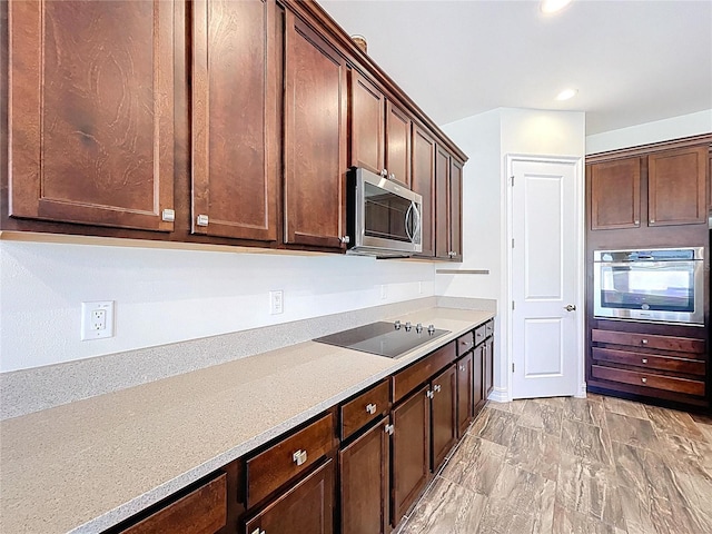 kitchen with light countertops, dark brown cabinetry, stainless steel appliances, and recessed lighting