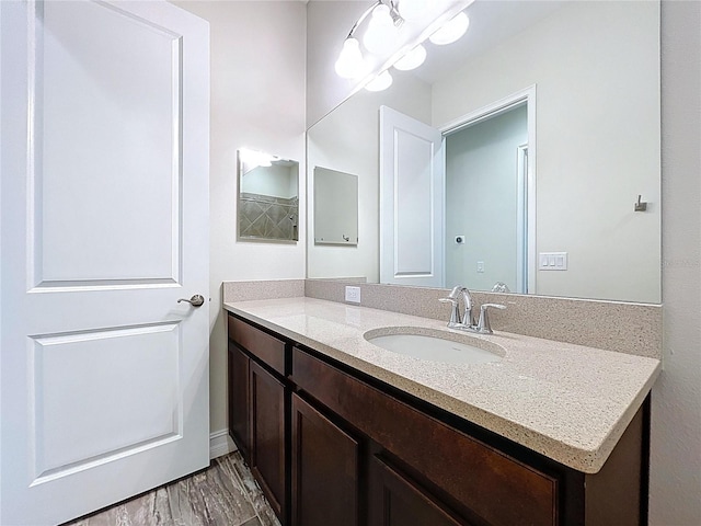 bathroom with vanity and wood finished floors