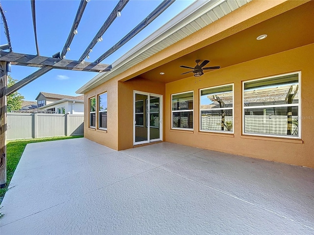 view of patio / terrace with fence and a ceiling fan
