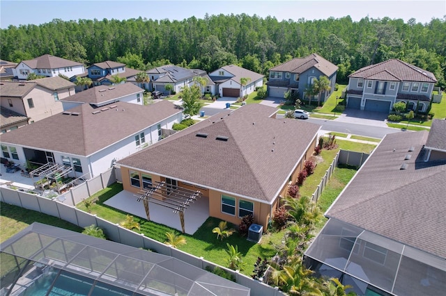 aerial view with a wooded view and a residential view