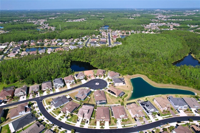 aerial view featuring a residential view, a water view, and a wooded view