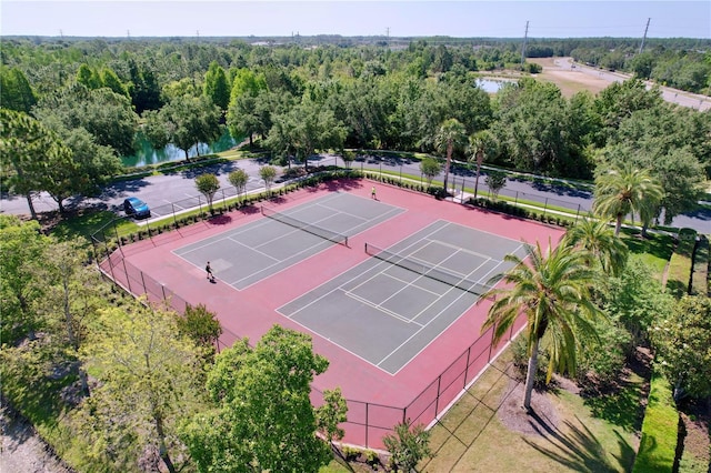 aerial view with a water view and a wooded view