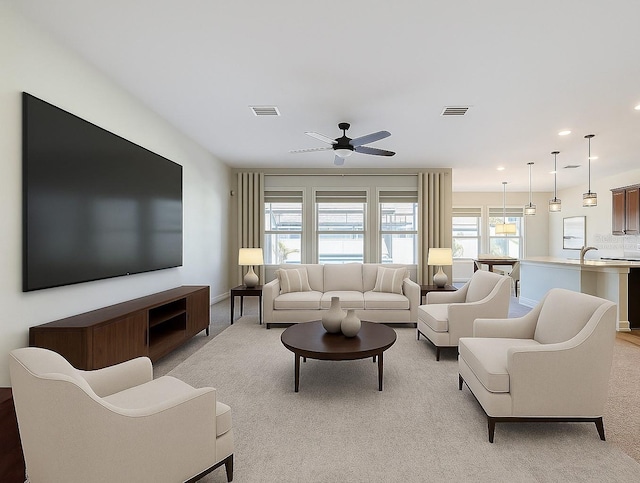 1723 Whitewillow Dr, Wesley Chapel, FL 33543 - living room featuring light carpet, a ceiling fan, recessed lighting, and baseboards