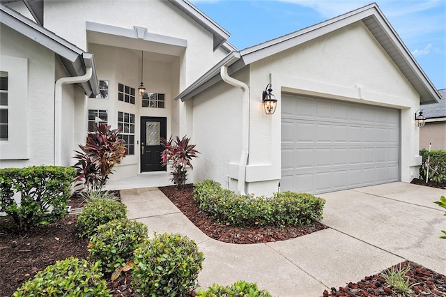 3023 Bent Creek Dr, Valrico, FL 33596 - property entrance with stucco siding, an attached garage, and driveway