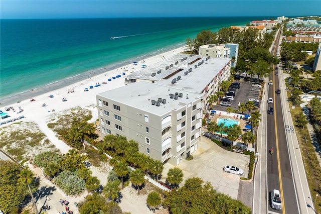 drone / aerial view featuring a beach view and a water view