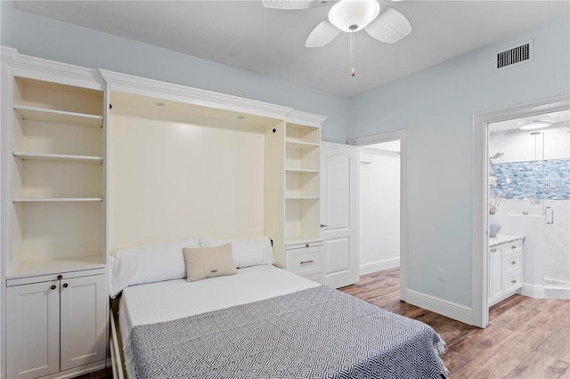 bedroom with connected bathroom, baseboards, visible vents, and light wood-style flooring