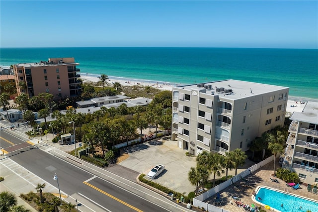drone / aerial view featuring a water view and a view of the beach