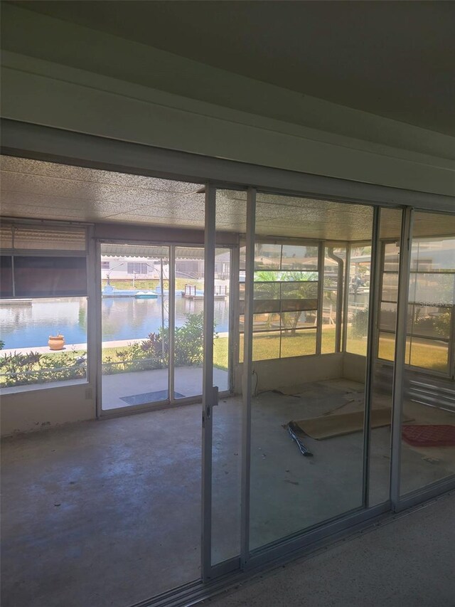 5105 Bonito Dr, New Port Richey, FL 34652 - unfurnished sunroom featuring a water view and a wealth of natural light