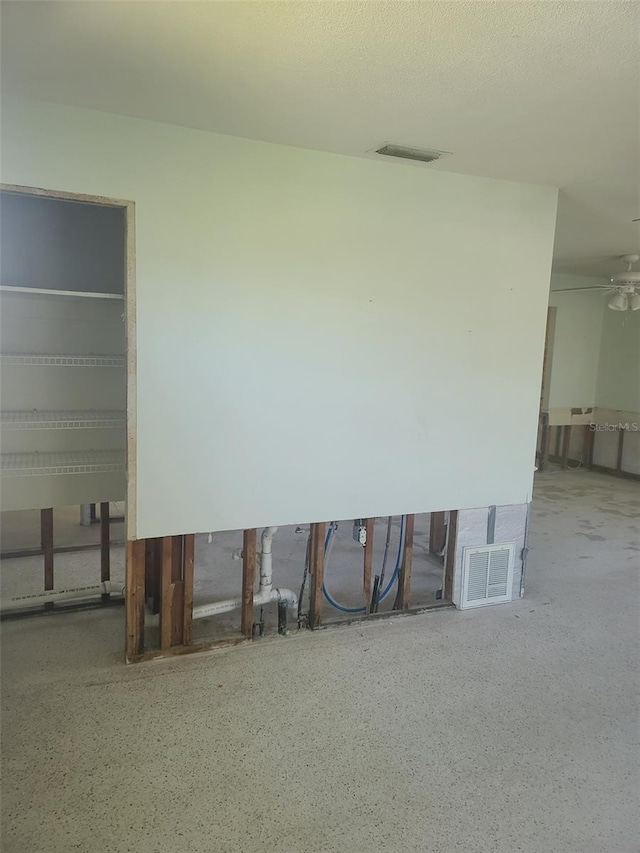 5105 Bonito Dr, New Port Richey, FL 34652 - interior space with ceiling fan, speckled floor, and visible vents
