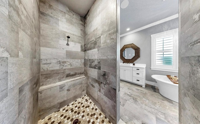 bathroom featuring a freestanding tub, vanity, crown molding, and tiled shower
