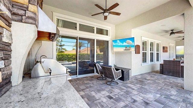 view of patio / terrace featuring grilling area, exterior kitchen, and a ceiling fan