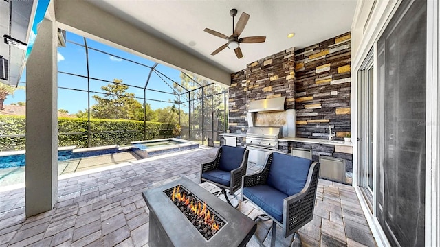 view of patio / terrace featuring area for grilling, ceiling fan, glass enclosure, a fire pit, and a grill