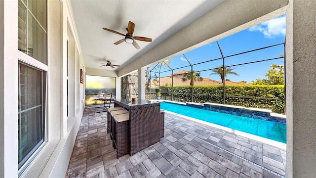 view of swimming pool with a lanai, a fenced in pool, a ceiling fan, and a patio area
