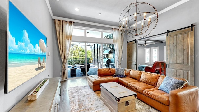 living area with light wood-style floors, a barn door, a chandelier, and recessed lighting