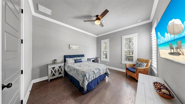 bedroom featuring crown molding, dark wood-style flooring, a ceiling fan, baseboards, and visible vents