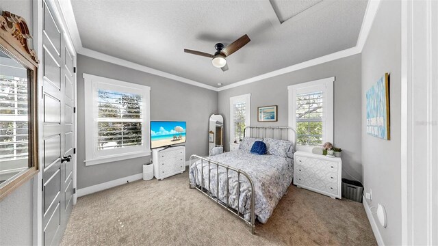 bedroom featuring baseboards, ornamental molding, light carpet, and a ceiling fan