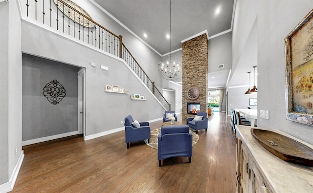 interior space featuring crown molding, baseboards, dark wood-type flooring, and a towering ceiling
