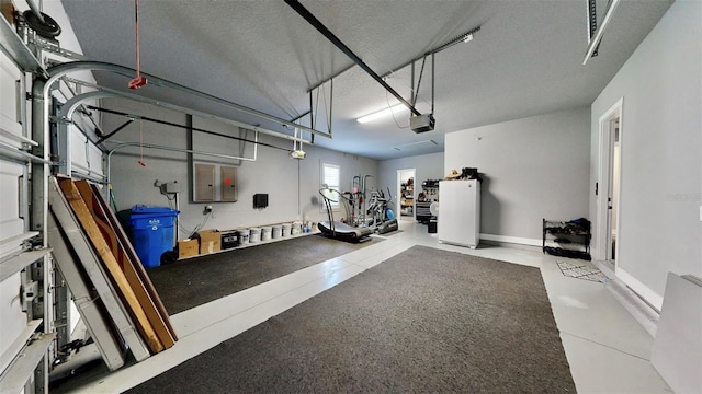 garage with a garage door opener and electric panel