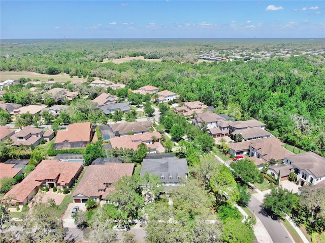 birds eye view of property featuring a view of trees and a residential view
