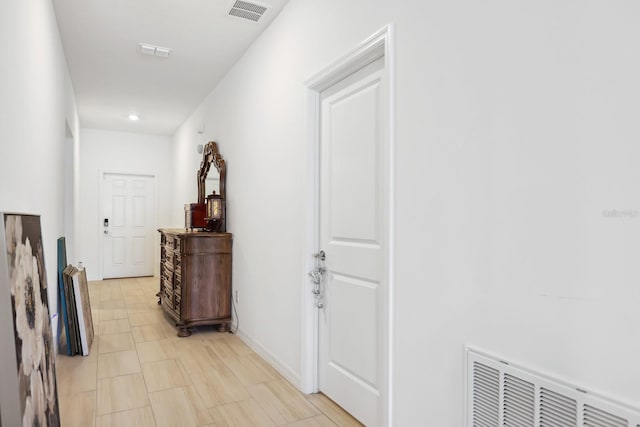 corridor with visible vents and baseboards