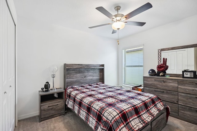carpeted bedroom with ceiling fan, baseboards, and a closet