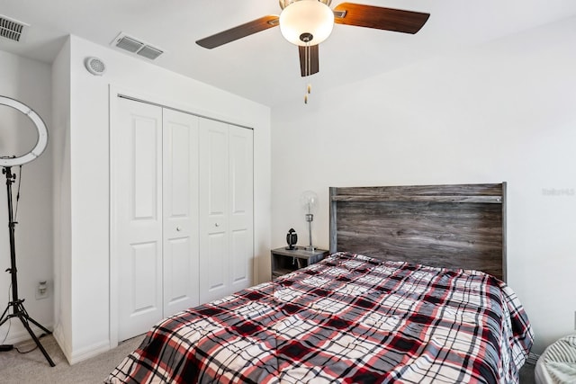 bedroom featuring a ceiling fan, light carpet, a closet, and visible vents