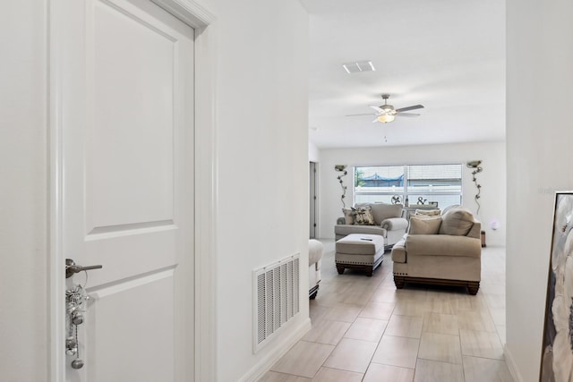 interior space with a ceiling fan and visible vents